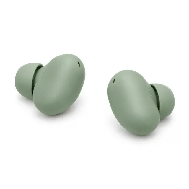She cradles two sage-green earbuds in her palm, seats them, and shows how the case disappears into a pocket.