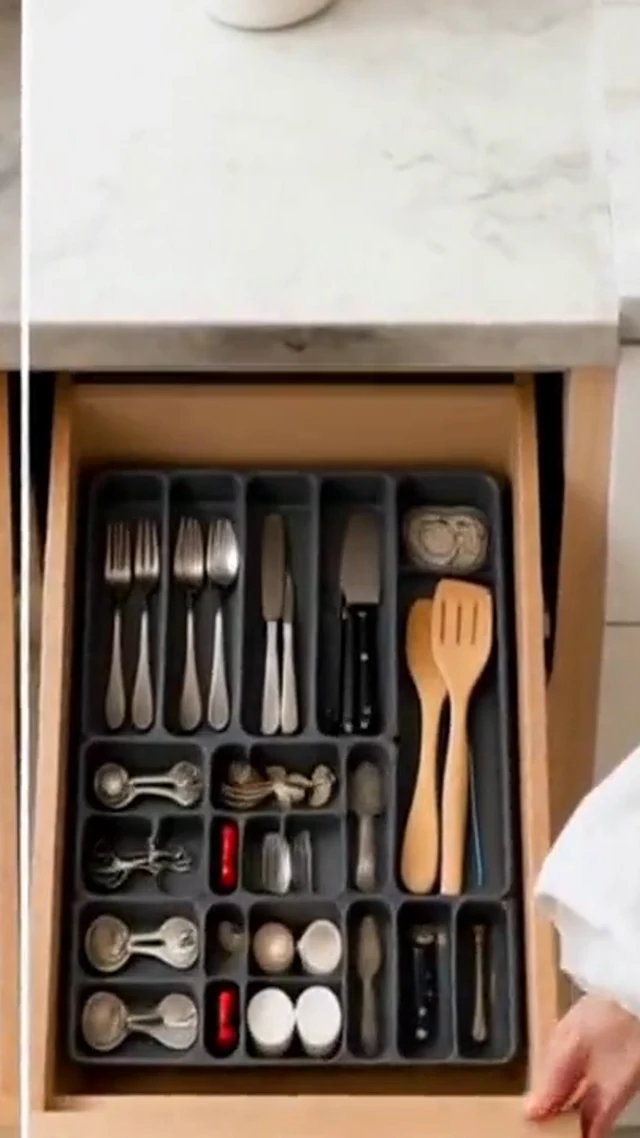 Hands organize gray drawer dividers and utensils in a vertical home organization video frame.