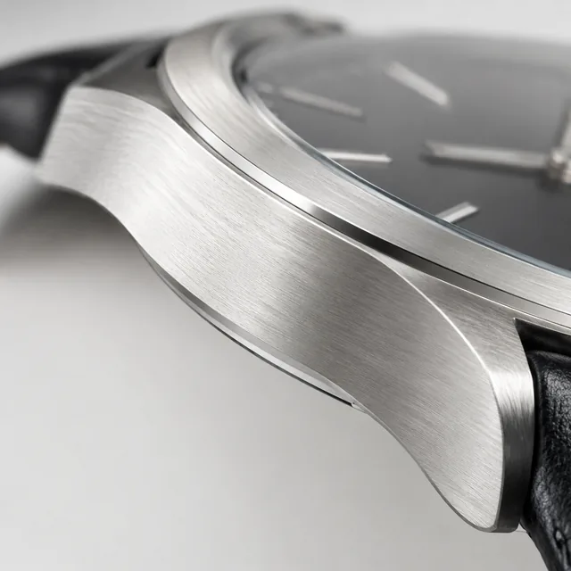 Macro close-up of the brushed metal edge of a watch case.