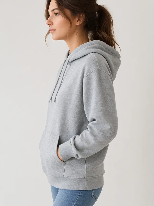 Model wearing a gray hoodie, side view to show the fit.