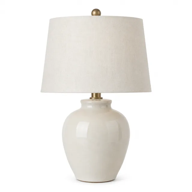 Ceramic table lamp with linen shade on a pure white background.