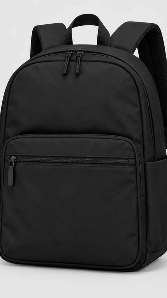 Black commuter backpack enlarged until one side edge is cut off by the frame.
