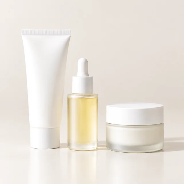 Cleanser, serum, and cream arranged together as a three-piece skincare set.