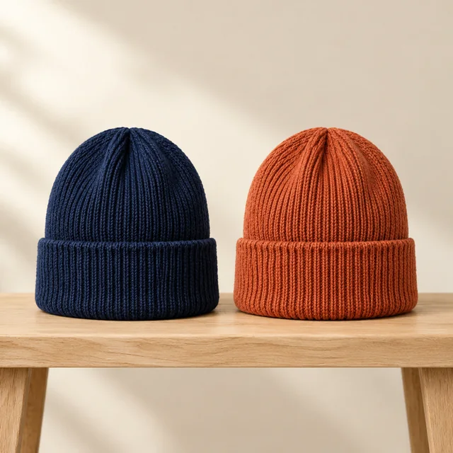 Navy and rust knit beanies shown side by side.