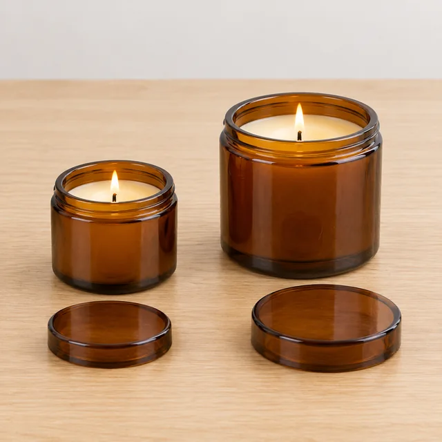 Small travel and standard candle jars shown side by side on a table.