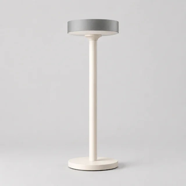 White sculptural saucer-shade desk lamp shown in a clean studio setting.