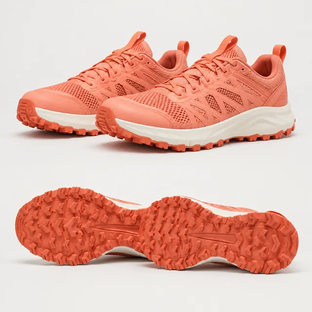 Pair of coral trail shoes with lugged soles photographed against a pale studio background.
