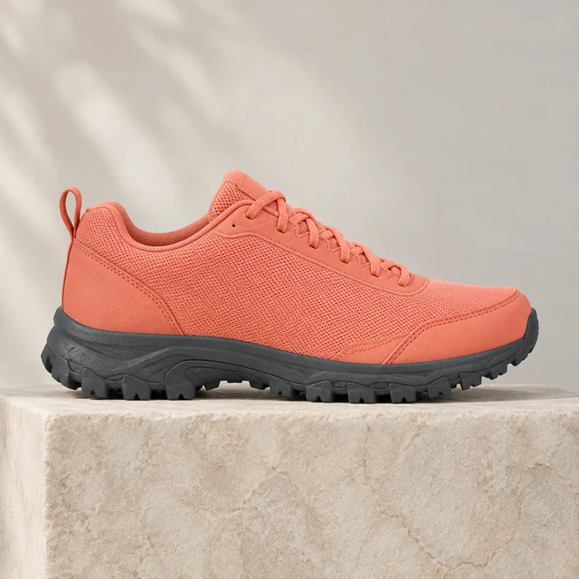 Unbranded coral trail shoe in side profile on a neutral studio background, plain panels and no lettering.