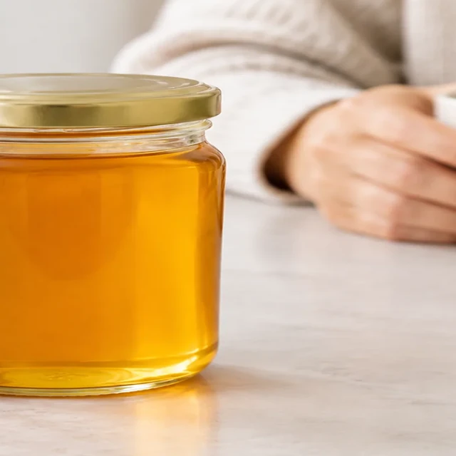 Honey jar partly cropped at the left frame edge.