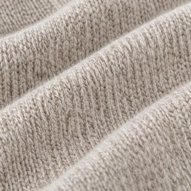 Close view of the knit texture of a merino sweater.