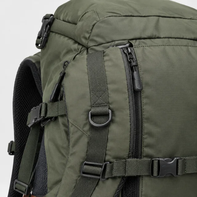 The same olive hiking backpack shown in a square close detail.