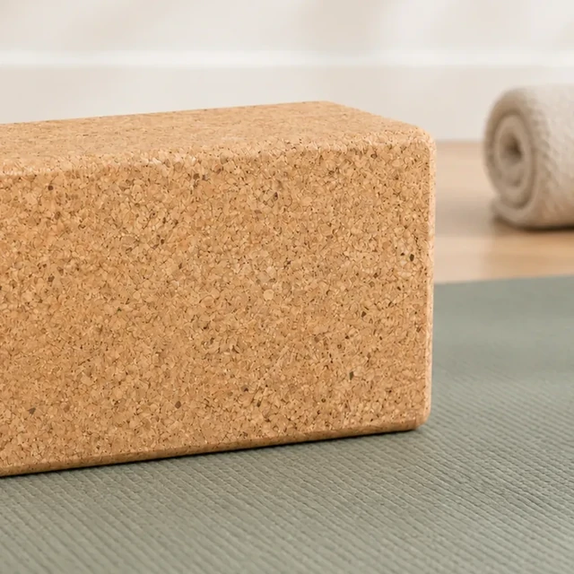 Cork yoga block with one short end clipped by the edge of the frame.