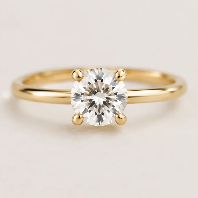 Clear gemstone secured by simple gold prongs, shown in sharp macro detail.