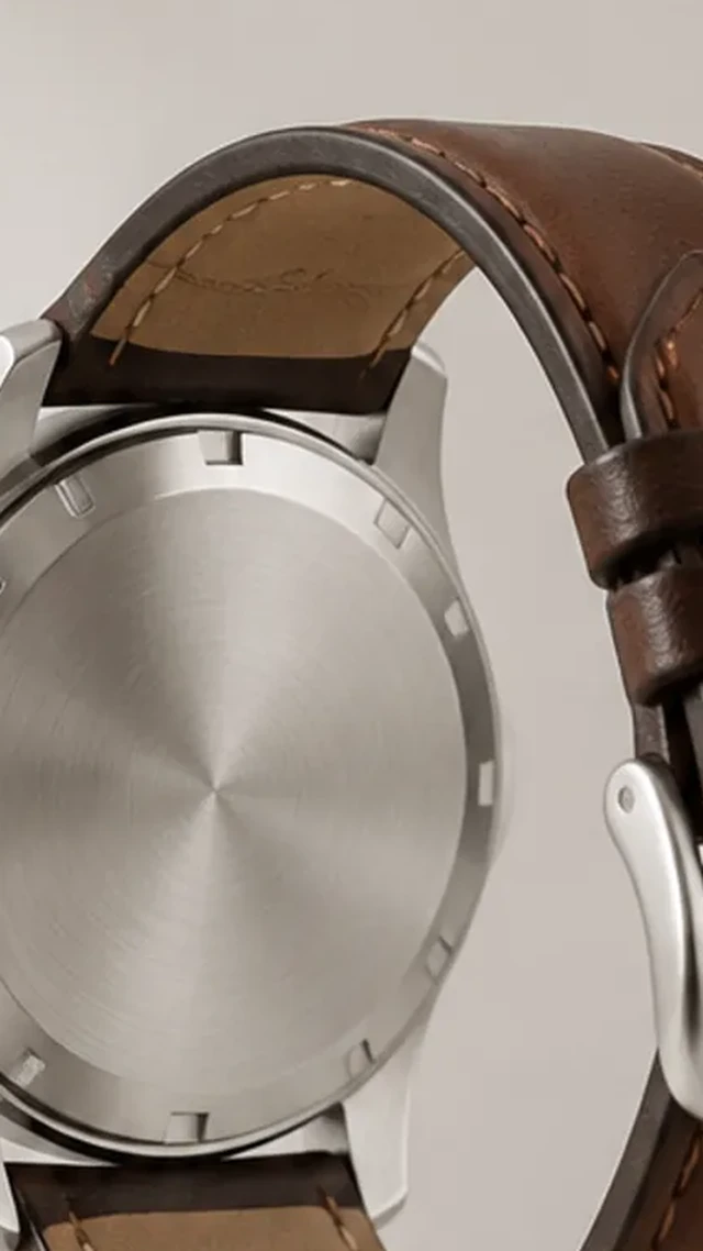 Wristwatch enlarged until its case and strap reach the frame edge.