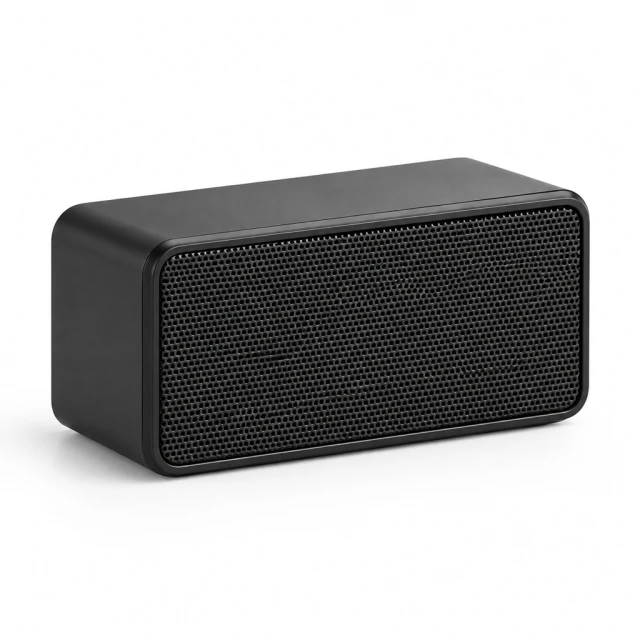 Compact black rectangular hard-shell speaker with a small front grille on a clean white surface, not cylindrical or fabric covered.