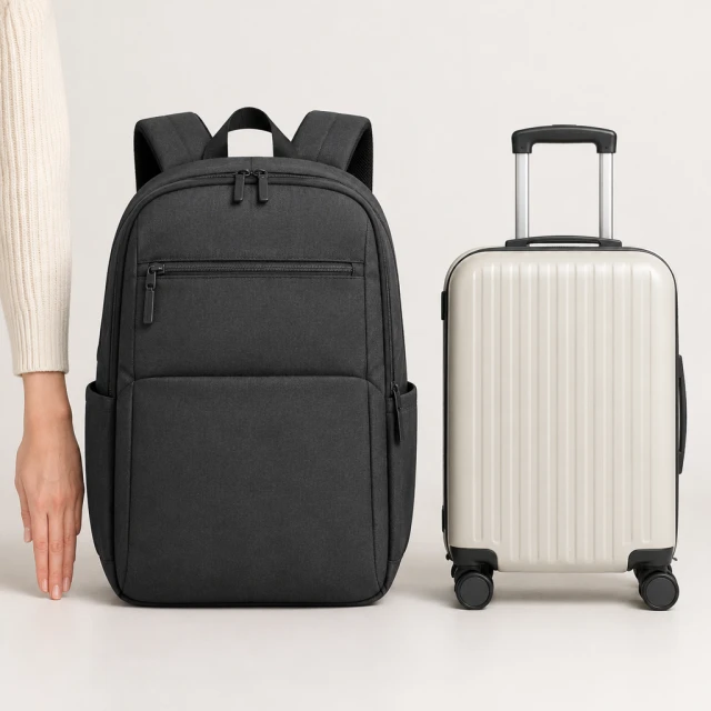 Unbranded commuter backpack beside a familiar carry-on bag and a hand for a clear scale comparison.