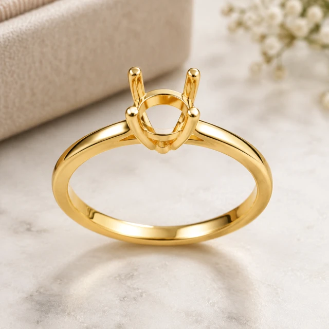 Macro square view of a simple gold ring setting with the prongs and polished band clearly visible.