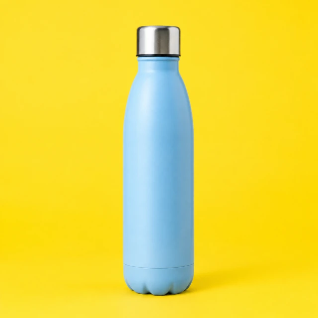 Plain reusable water bottle centered against a vivid yellow studio backdrop, full outline visible.