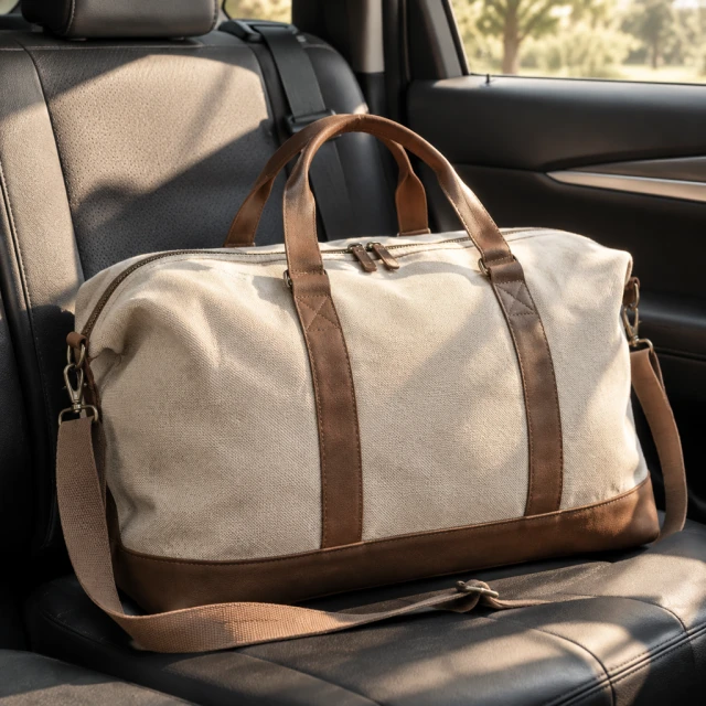 Canvas weekender bag resting on the back seat of a parked car in warm afternoon light.