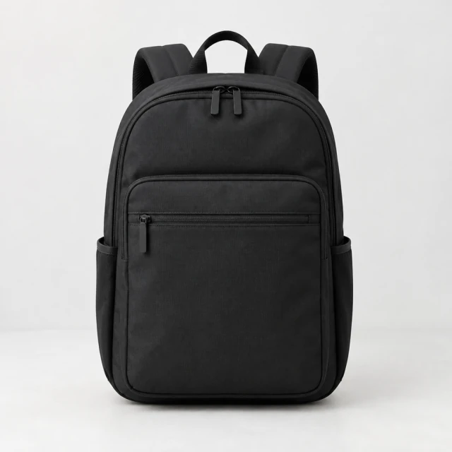 Black commuter backpack, front view, centered on a pale studio background