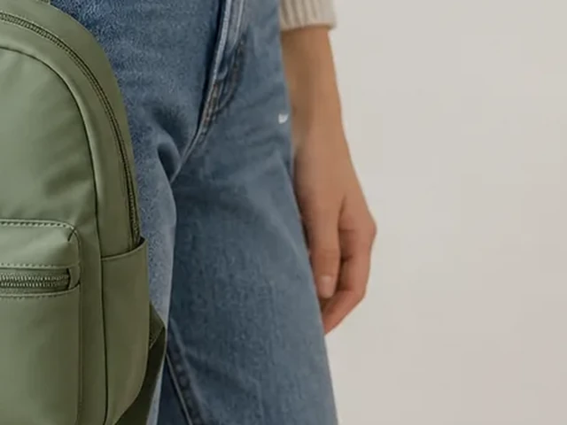 Mini backpack cut off at the side edge by a tight crop.