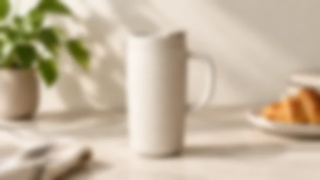 Ceramic travel mug with its rim and glaze softly out of focus.