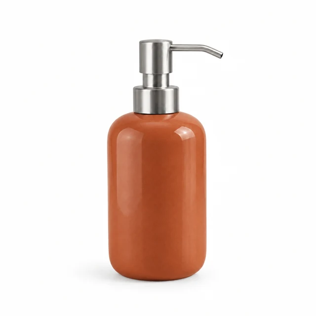 Single soap dispenser with warm terracotta glaze against pure white.