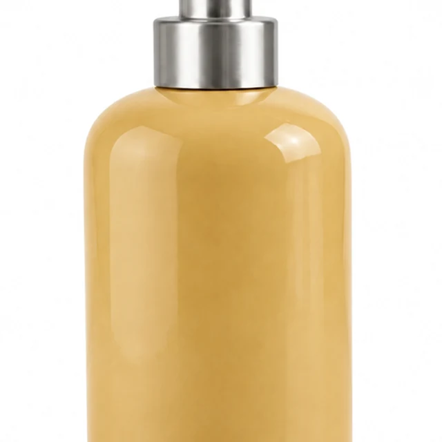 The same soft ochre soap dispenser tightly cropped at the frame edges.