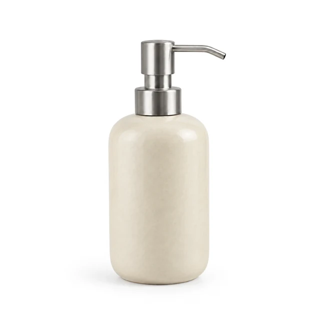 Unbranded ceramic soap dispenser in matte cream glaze with a brushed metal pump on white.