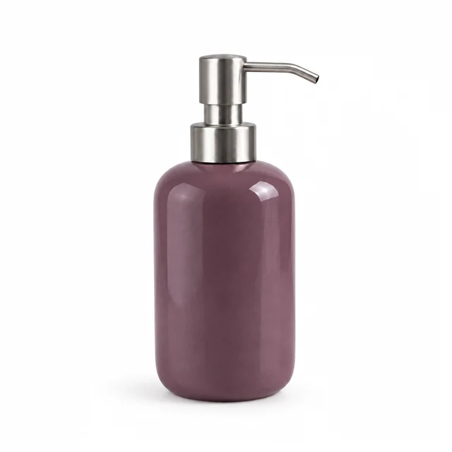 Unbranded ceramic soap dispenser in muted plum glaze with a brushed metal pump on white.