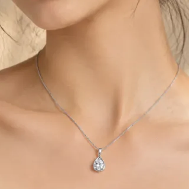 Square crop of a silver pendant necklace on a model.