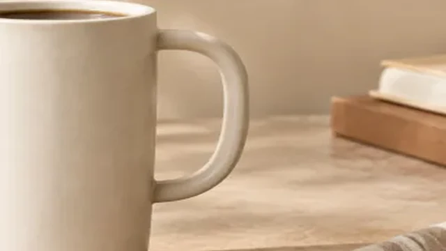 Travel mug cropped tightly with its left edge cut off.