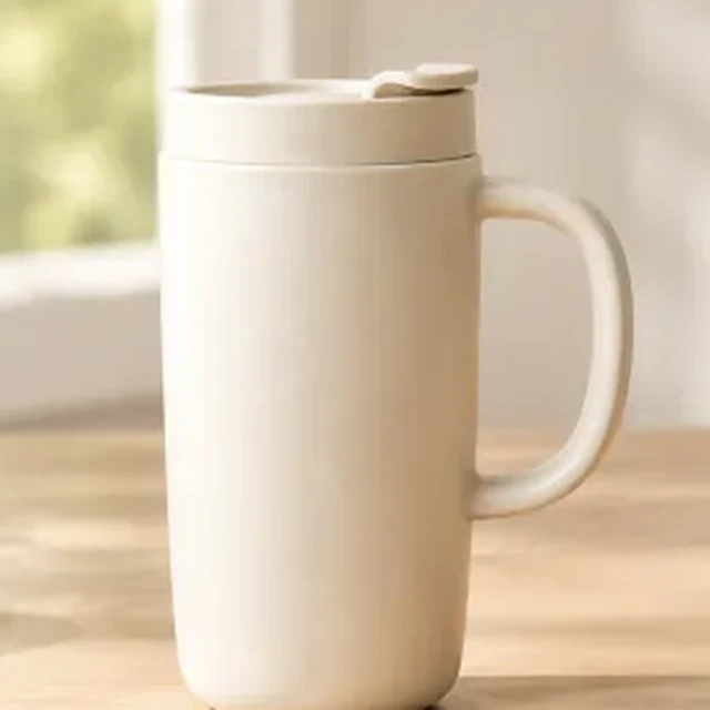 Square crop of a matte cream ceramic travel mug with controlled highlights.