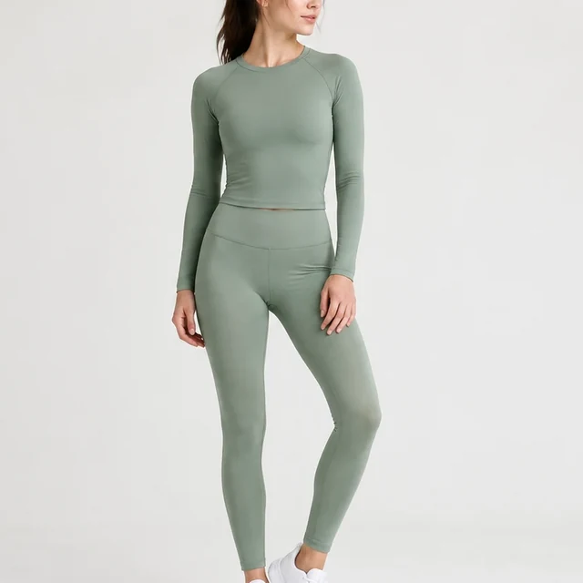 Square crop of an adult model wearing a muted sage athletic set.