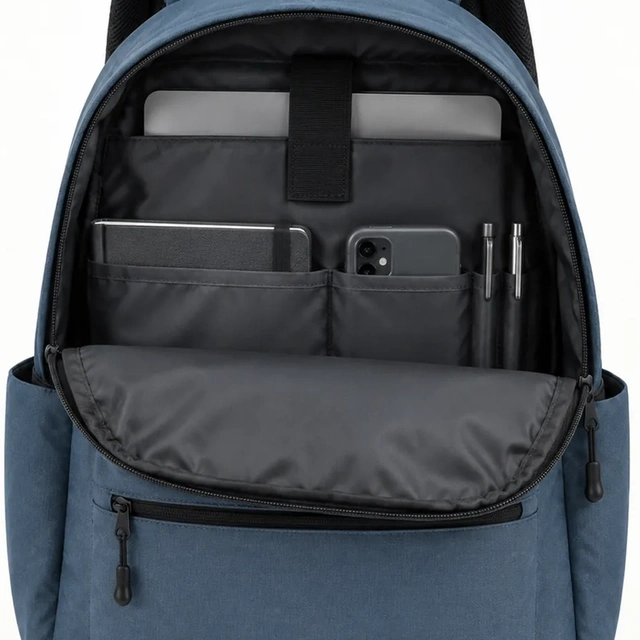 Open blue daypack with its top handle cropped by the frame.