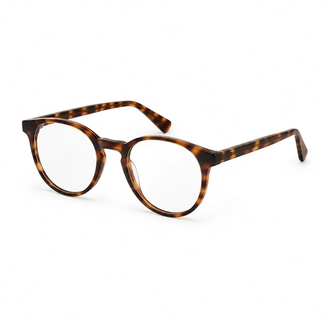 Tortoiseshell reading glasses shown open on seamless white.