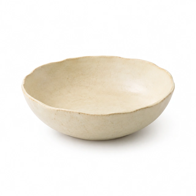Cream stoneware serving bowl shown alone on seamless white.