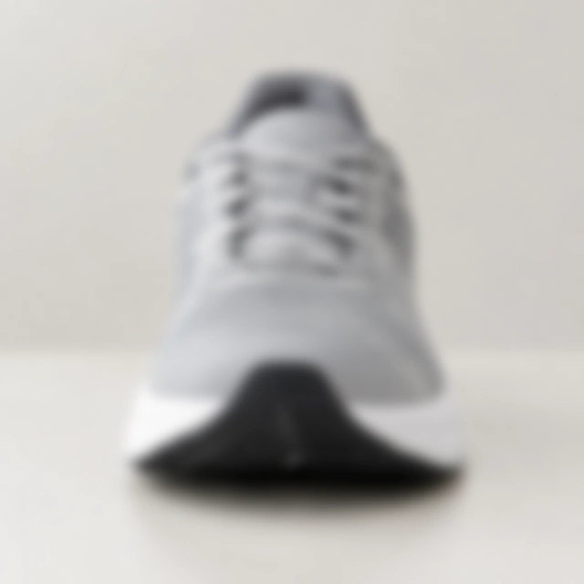 Running shoe softened out of focus so its shape and laces are unclear.