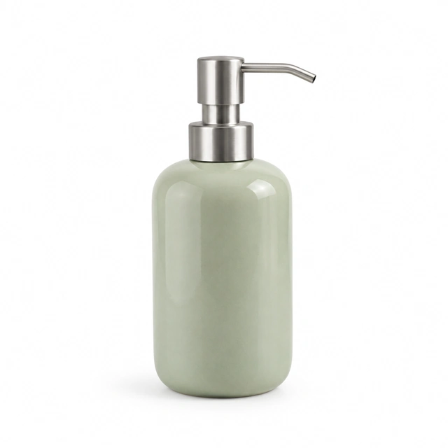 Pale sage ceramic soap dispenser with a brushed metal pump on seamless white.