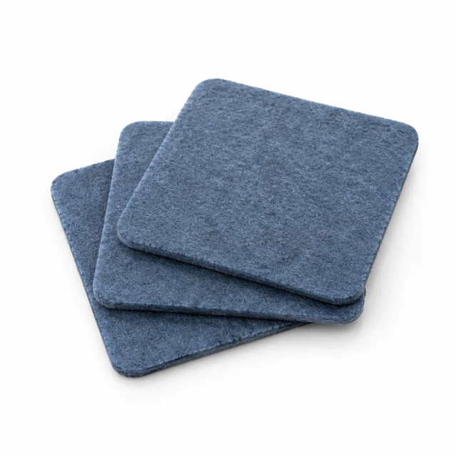 Three slate-blue felt coasters arranged in a neat stack on white.