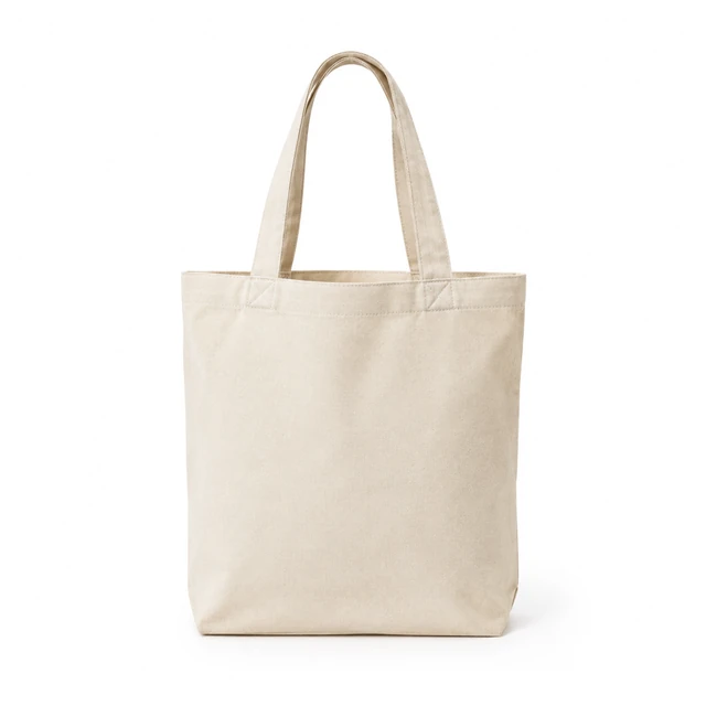 Natural canvas tote bag with sturdy handles, upright on white.
