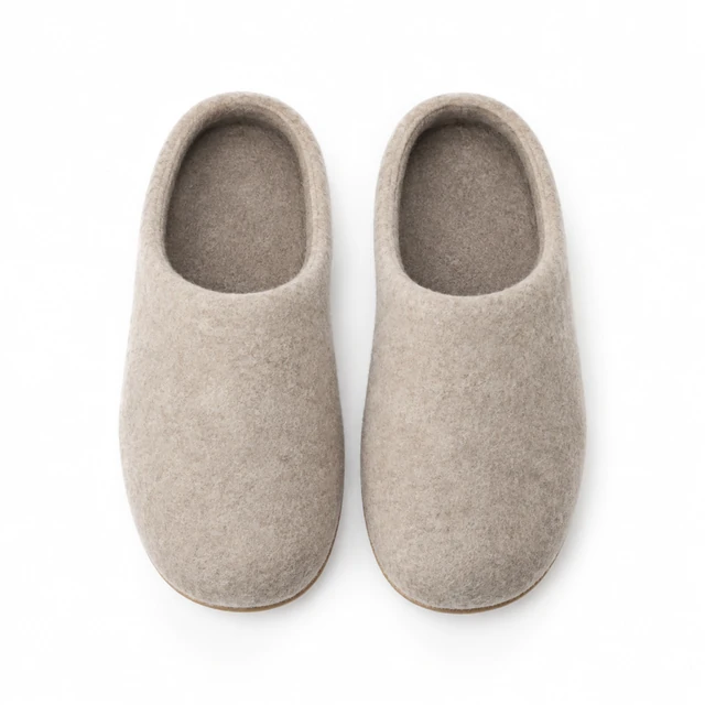 Pair of oatmeal felt house slippers on seamless white, both fully visible.