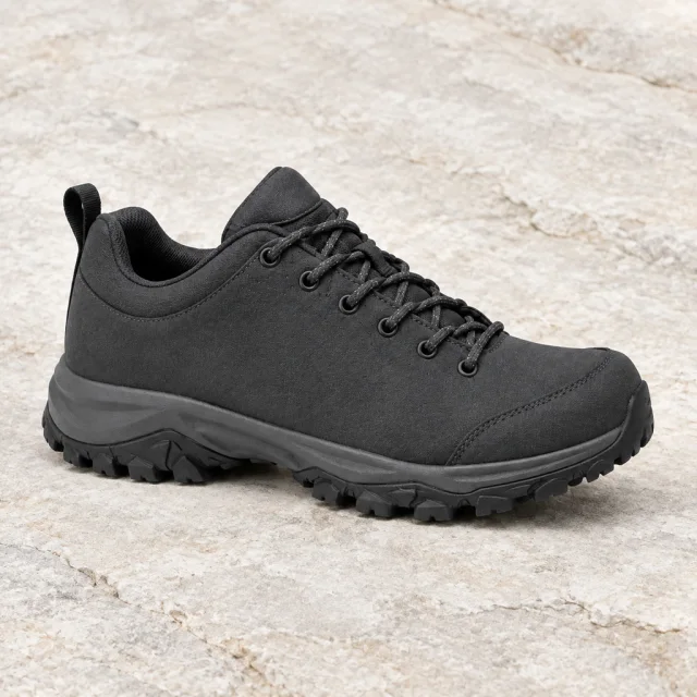 Plain charcoal hiking shoe in a crisp three-quarter view on pale stone.