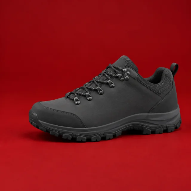 Plain charcoal hiking shoe on a clean red backdrop.