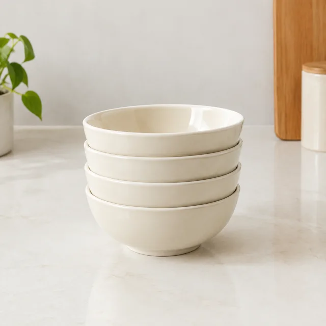 Stacked ceramic bowls on a counter with clear space above them.