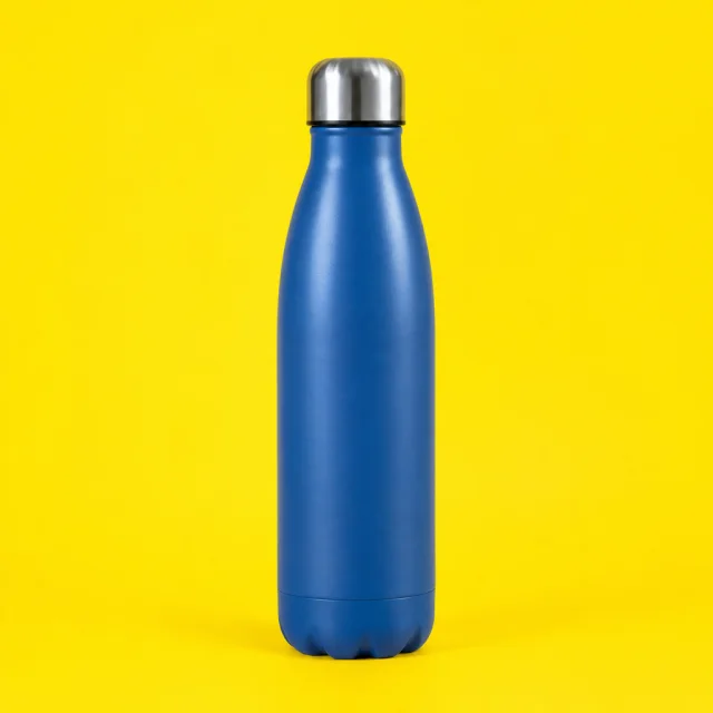 Reusable bottle on a bright yellow surface.
