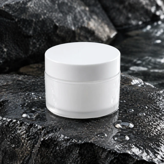 Plain face cream jar on wet stone