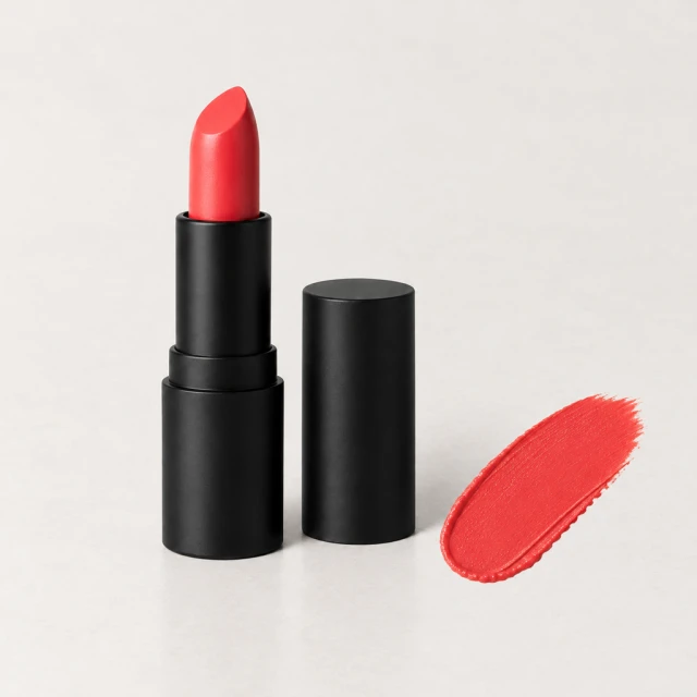 Coral lipstick beside a matching color swatch