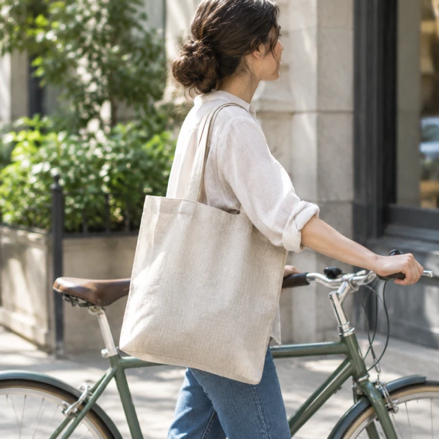 Linen tote bag carried beside a city bike.
