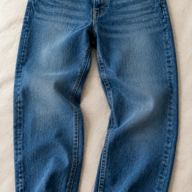 Blue jeans tightly cropped at the top and bottom edges
